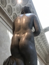 a statue of a nude woman in a museum
