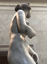 a statue of a naked woman in a museum