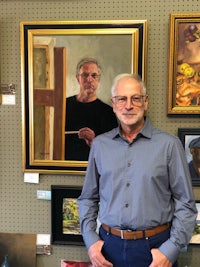 Peter Antonellis standing before his self portrait painted in oils. 
